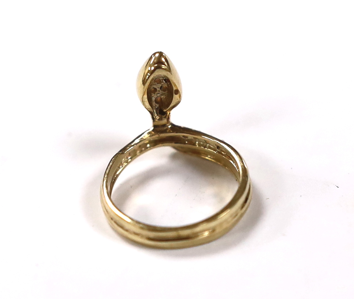 A modern 9ct gold and white opal cluster set serpent ring, size M, gross weight 3.7 grams.